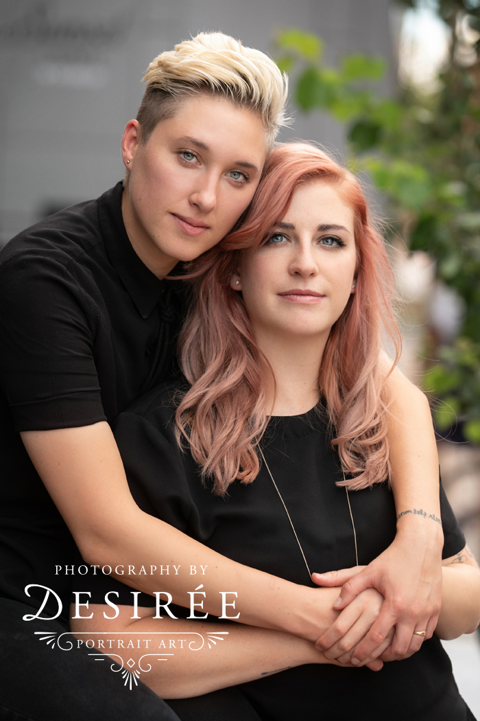 serious portrait of beautiful lesbian couple leaned into one another