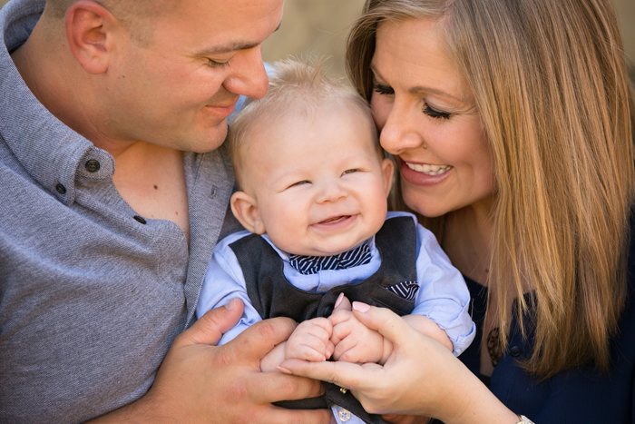 closeup of parents with their baby boy smiling and laughing