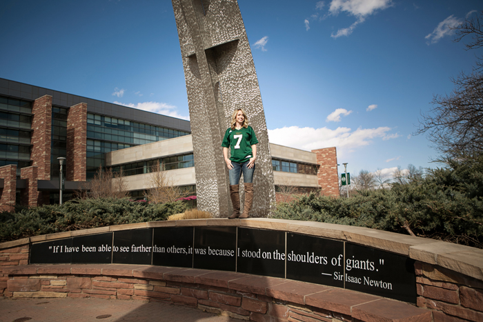 college grad in front of CSU landmark