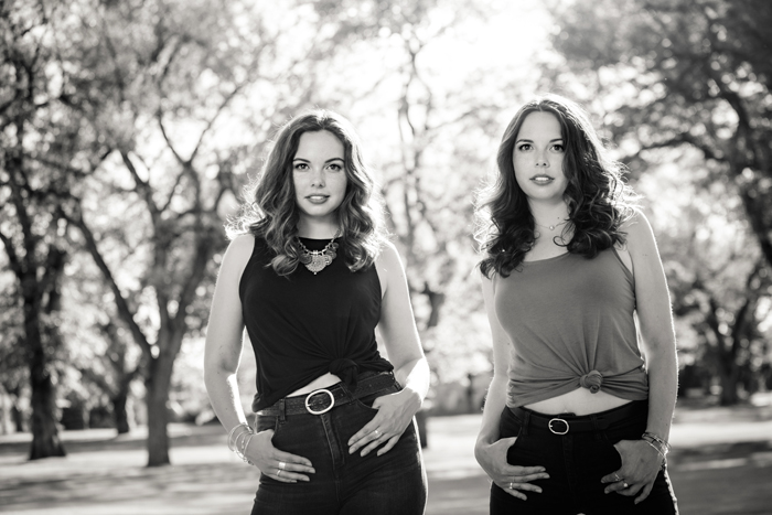 black and white low camera angle of twins women in power poses