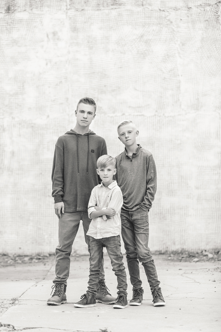 Serious black and white portrait of 3 brothers taken during their family session in Old Town Ft. Collins