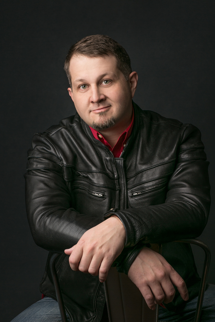 Studio branding portrait of a young plumber wearing a leather jacket