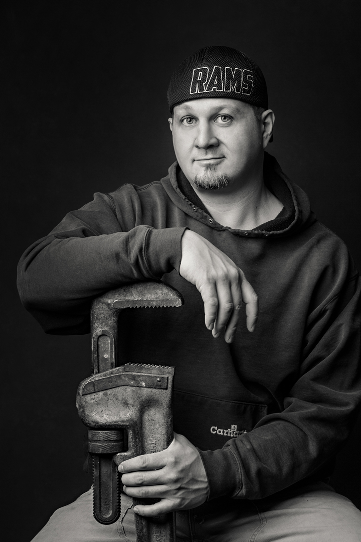 Studio lifestyle business portrait of a man with his tools