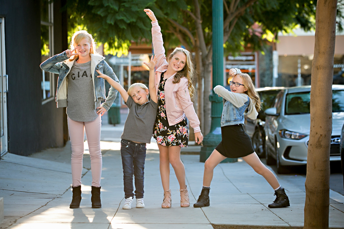 Sibling shot taken in Urban San Diego in Little Italy, 4 kids being silly and smiling