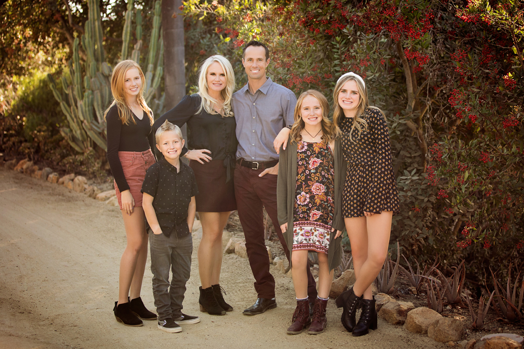 Family photo of a mother, father and their four children—three older daughters and the youngest is a boy. Taken by Photography by Desirée in Fort Collins, CO