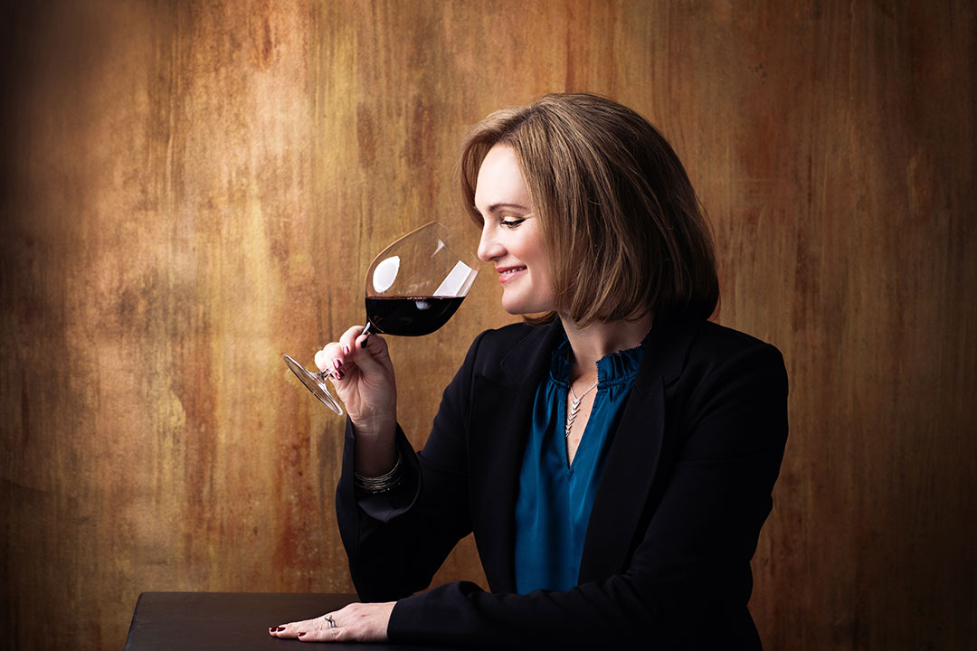 Elegant photo of a sommelier sipping wine for her personal branding photo session in  Northern Colorado