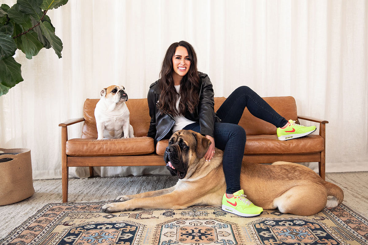  Branding portrait of a laid back lawyer with her two dogs; a mastiff and a bulldog at her feet 